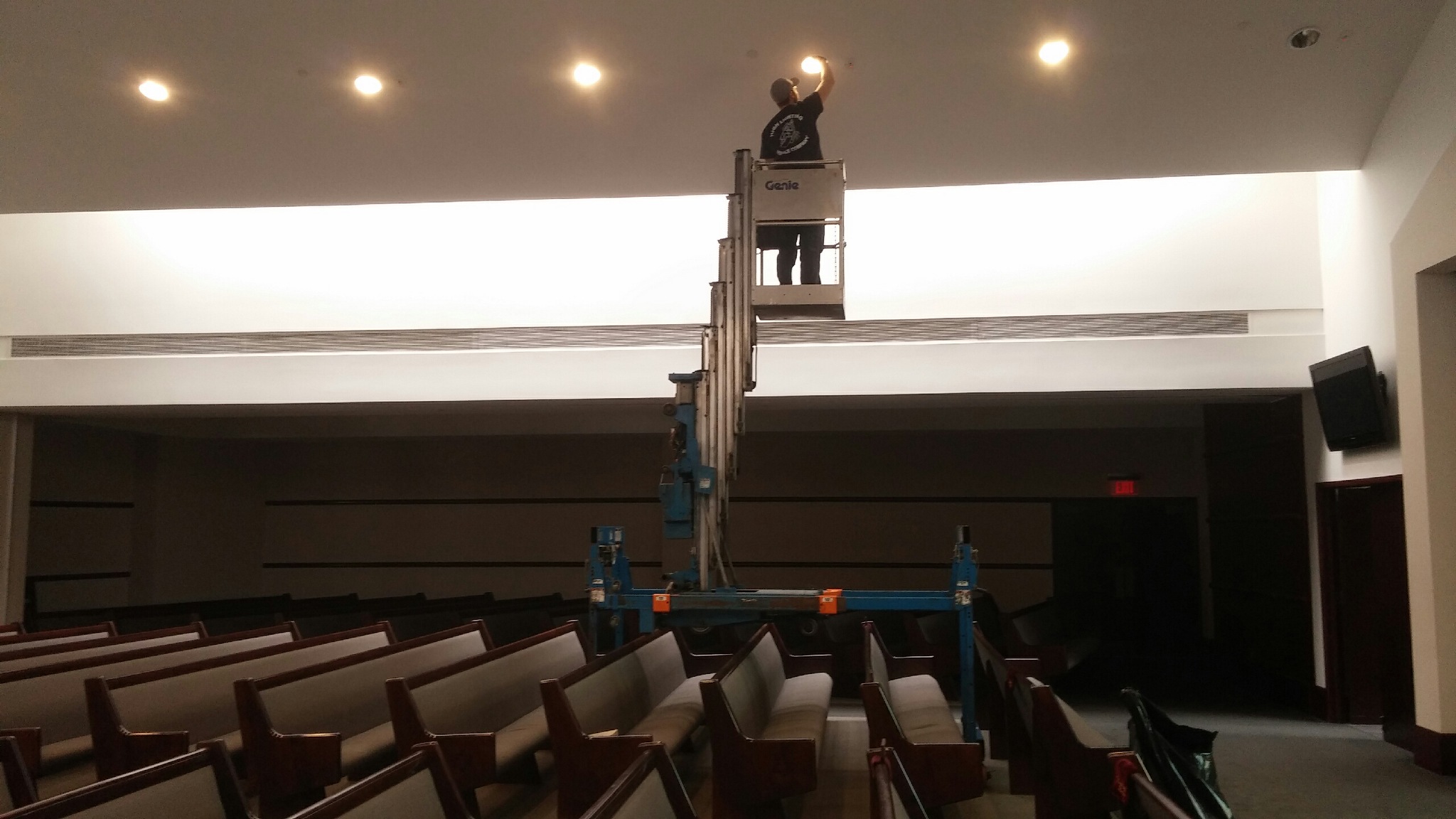 Changing high area lighting inside a chapel using a man lift 