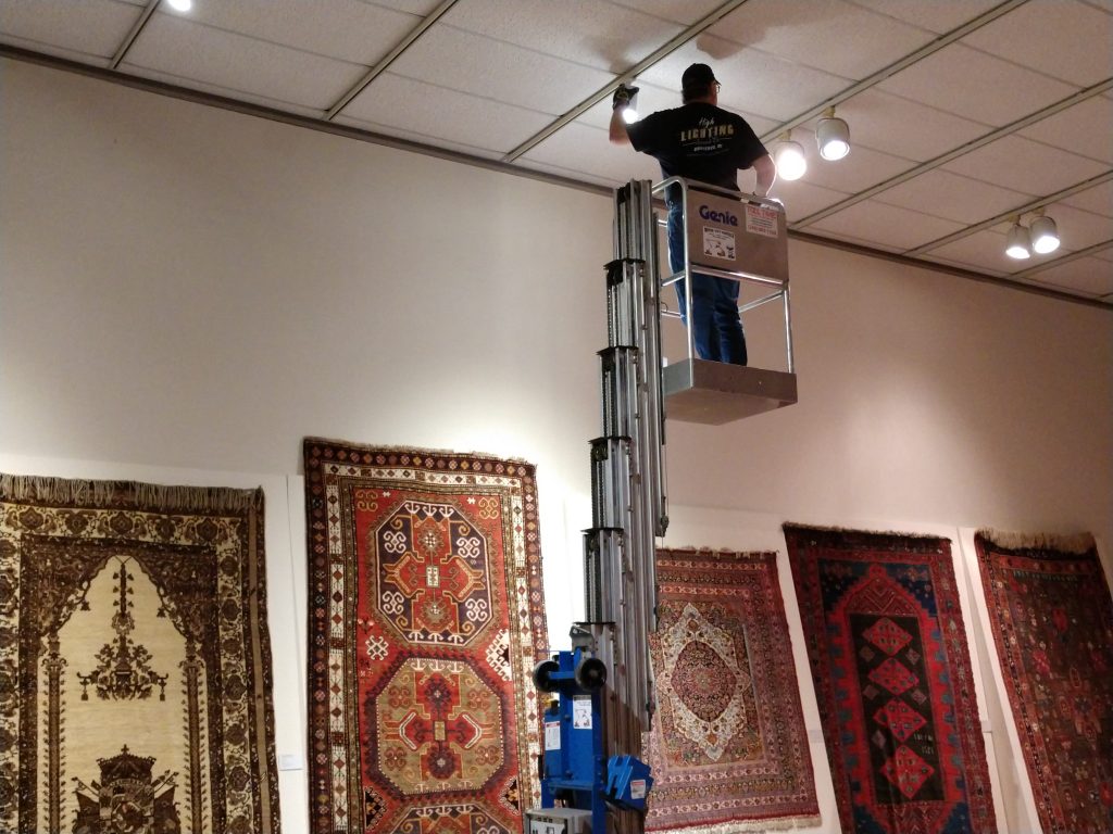 Eddie is installing the new LED fixtures in the carpet room.