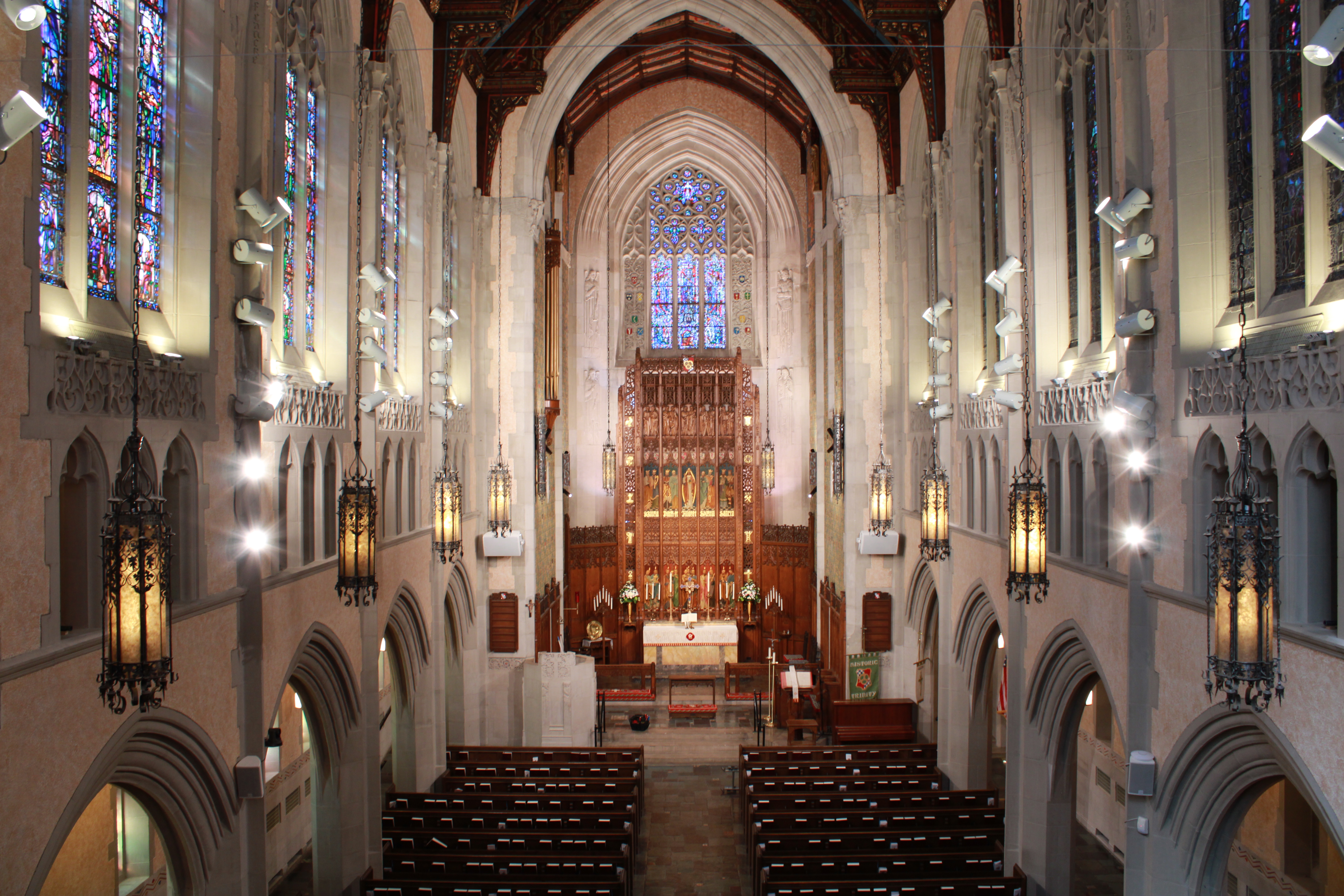 A view of the sanctuary inside of Historic Trinity Lutheran Church of Detroit, also showing Parker Reed Lighting's LED fixtures with McWong International's wireless bluetooth mesh modules