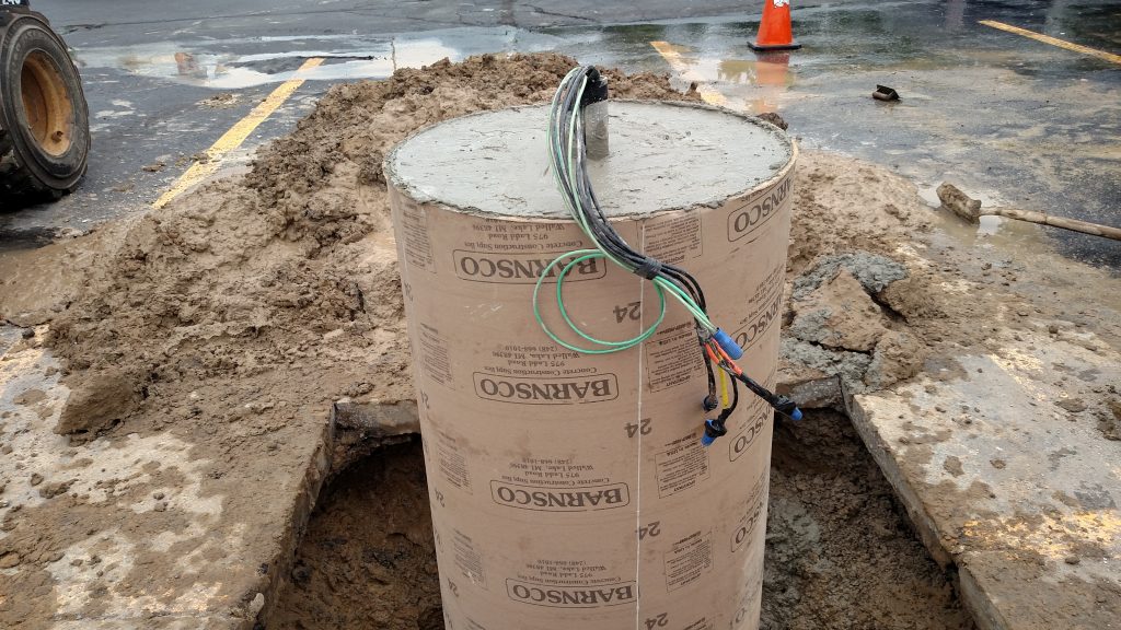 A newly poured parking lot pole base.
